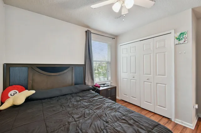 a bedroom with a bed and a chandelier