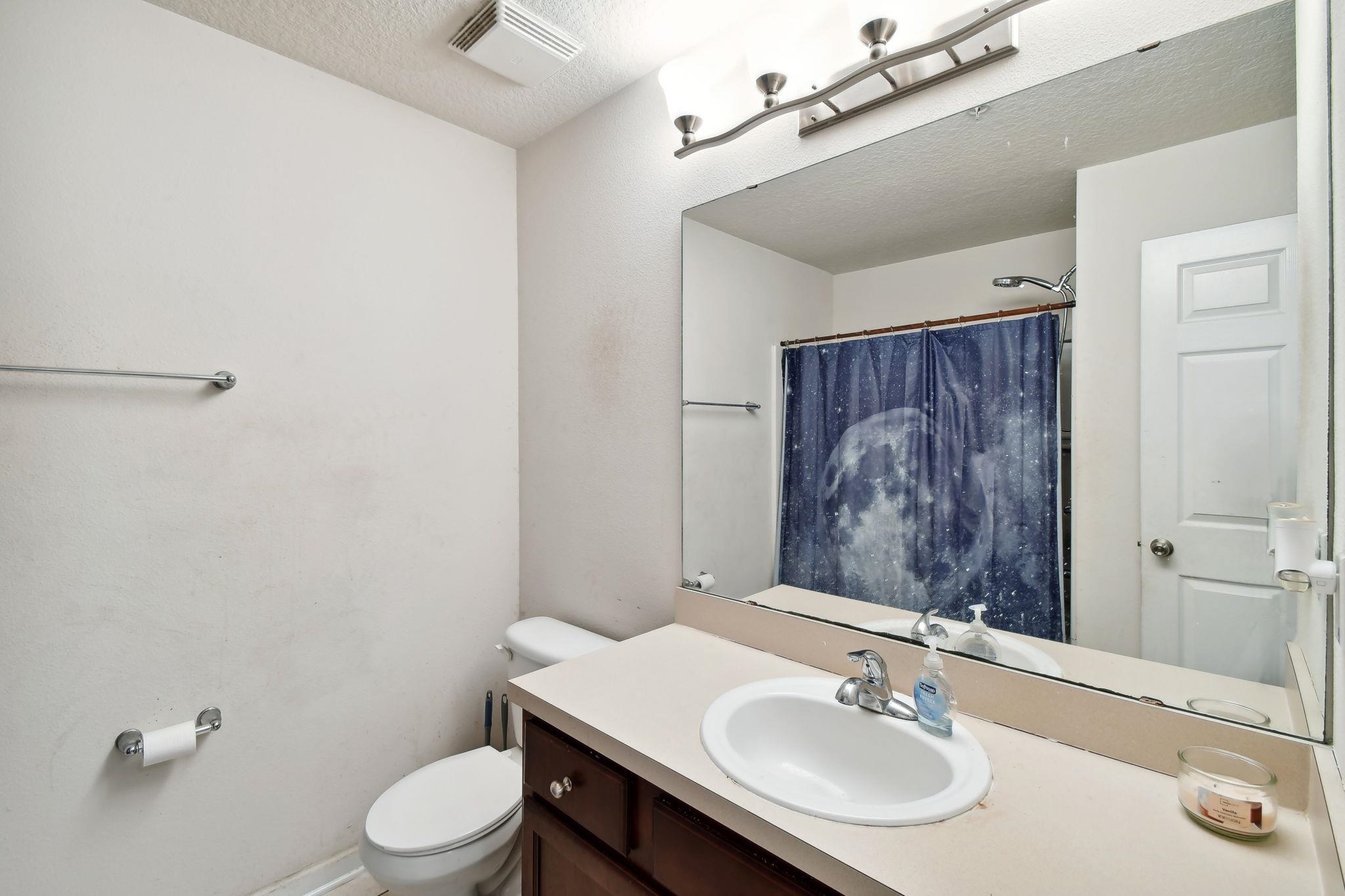 2481 Golden Lake Loop St. Augustine, FL 32084 - Photo 16 of 39 a bathroom with a sink toilet and mirror
