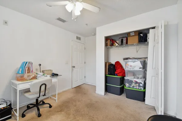 a bedroom with a workspace