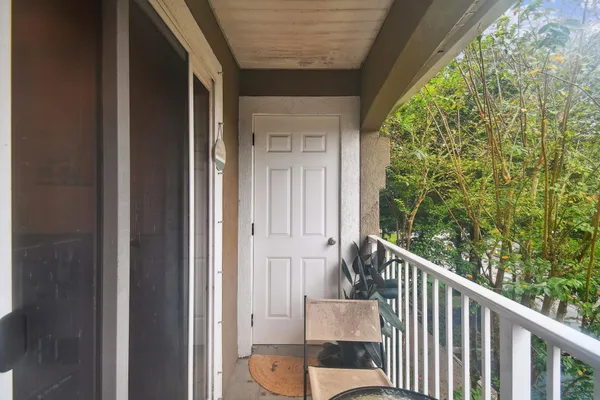 a view of a balcony with wooden floor