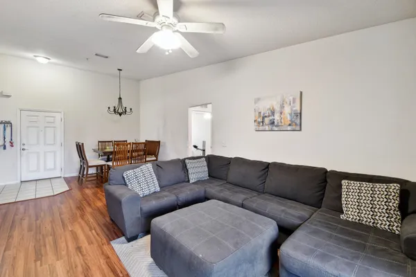 a living room with furniture and wooden floor