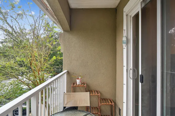 a view of a balcony with wooden floor and stairs