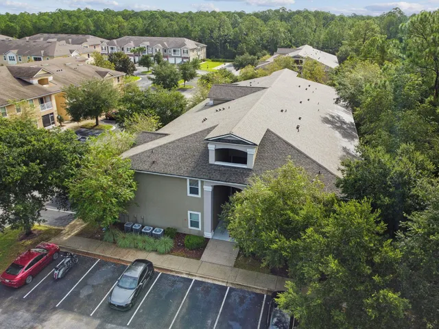 an aerial view of a house with garden space and street view