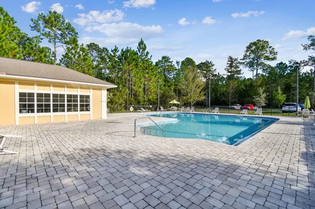 an aerial view of a house with swimming pool patio and outdoor seating