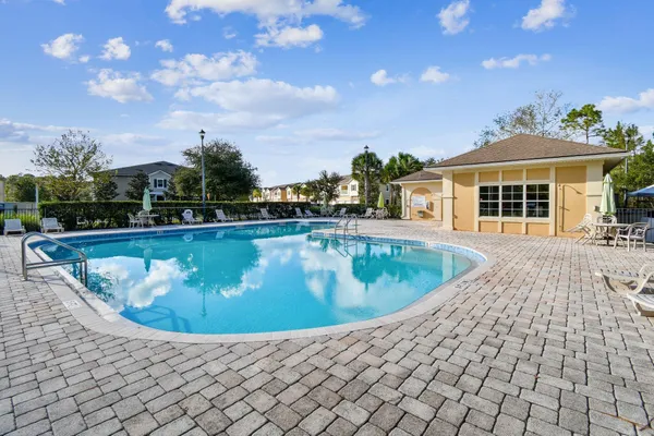 an aerial view of a swimming pool playground and residential houses with outdoor space