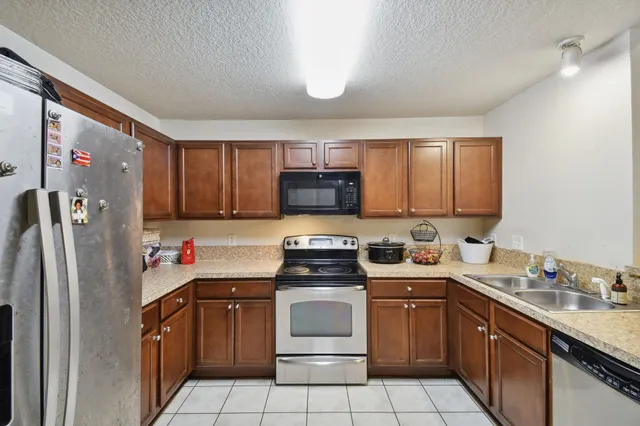 a kitchen with a sink stove and refrigerator
