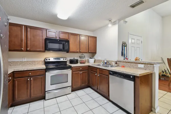 a kitchen with stainless steel appliances granite countertop a sink and cabinets