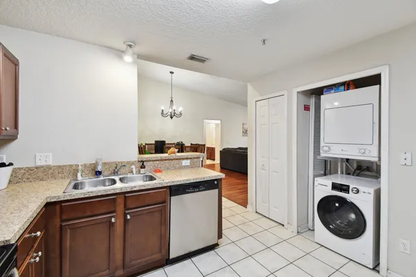 a kitchen that has a sink and cabinets in it