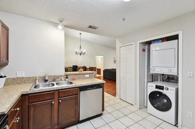 a kitchen that has a sink and cabinets in it