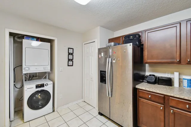 a kitchen with a refrigerator and washer