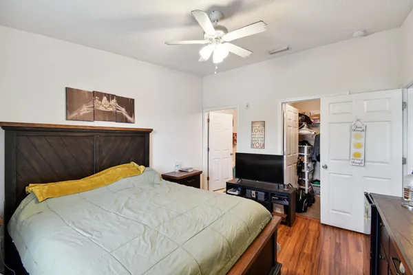 a bedroom with a bed and a flat screen tv