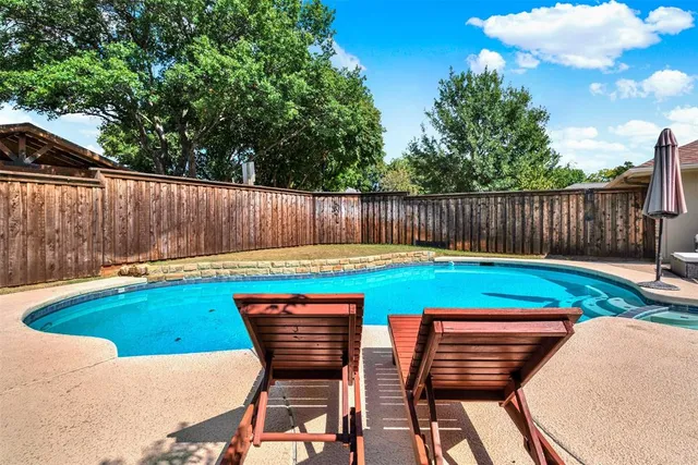 a view of swimming pool with a backyard