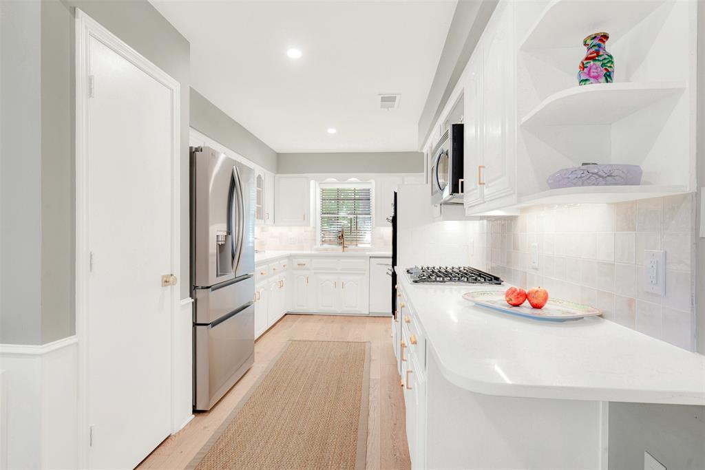 1601 Geneva Lane Plano, TX 75075 - Photo 7 of 38 a kitchen with stainless steel appliances a refrigerator and a sink