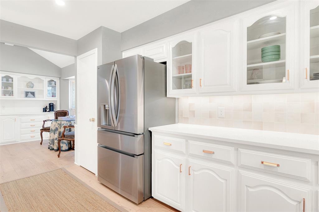 1601 Geneva Lane Plano, TX 75075 - Photo 9 of 38 a kitchen with stainless steel appliances a refrigerator and cabinets