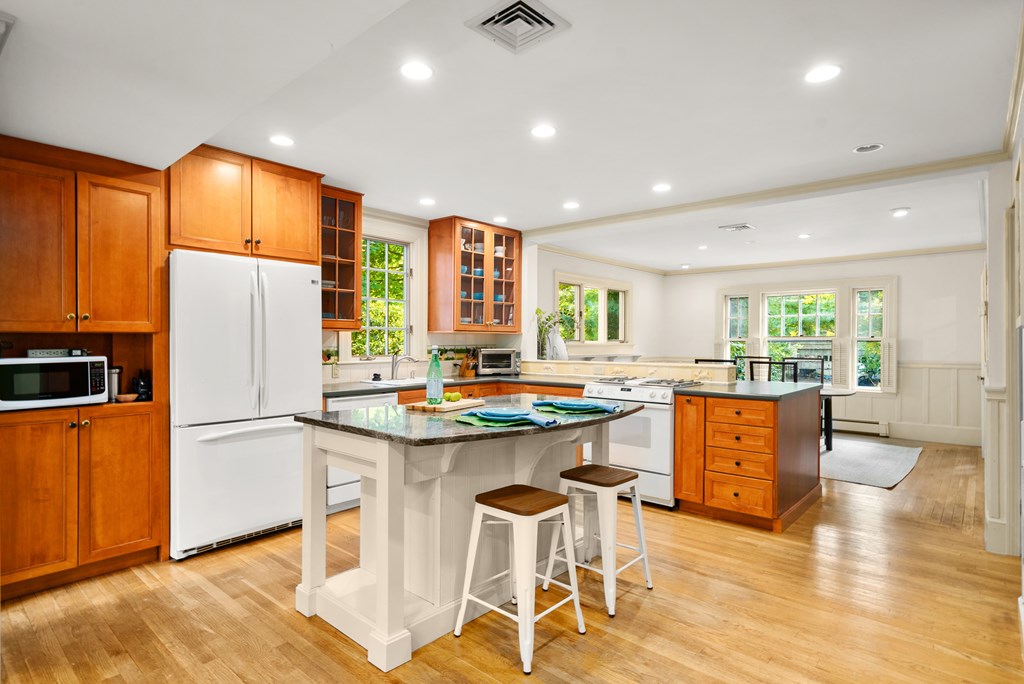 34 Upland Road Newton, MA 02468 - Photo 13 of 33 a kitchen with stainless steel appliances granite countertop a refrigerator a sink dishwasher and a stove with wooden floor
