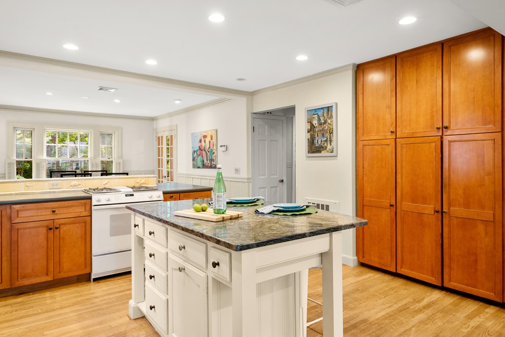 34 Upland Road Newton, MA 02468 - Photo 15 of 33 a kitchen with stainless steel appliances granite countertop a stove a sink dishwasher and a refrigerator with wooden floor