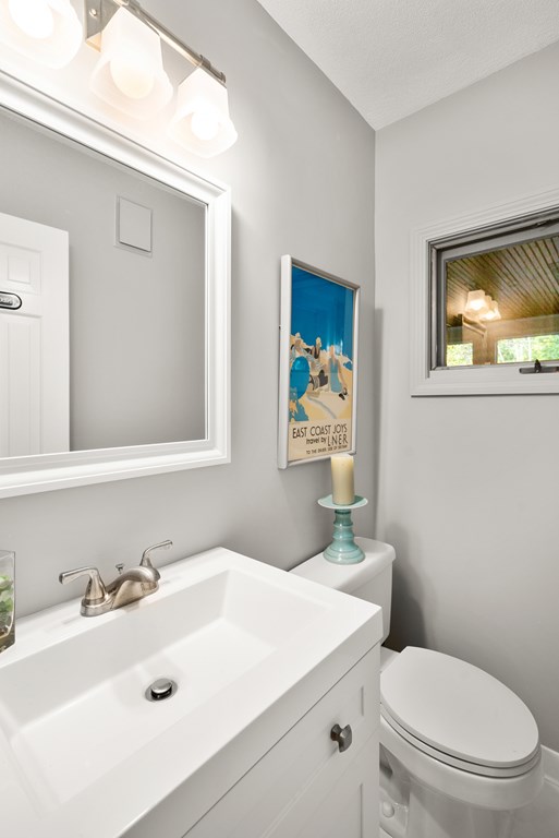 34 Upland Road Newton, MA 02468 - Photo 17 of 33 a bathroom with a sink a toilet and mirror