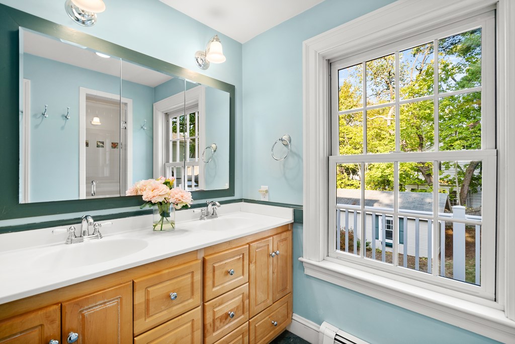 34 Upland Road Newton, MA 02468 - Photo 25 of 33 a bathroom with a granite countertop sink and a large mirror