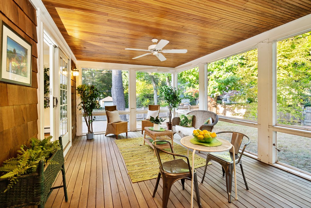 34 Upland Road Newton, MA 02468 - Photo 8 of 33 a view of a patio with table and chairs and wooden floor
