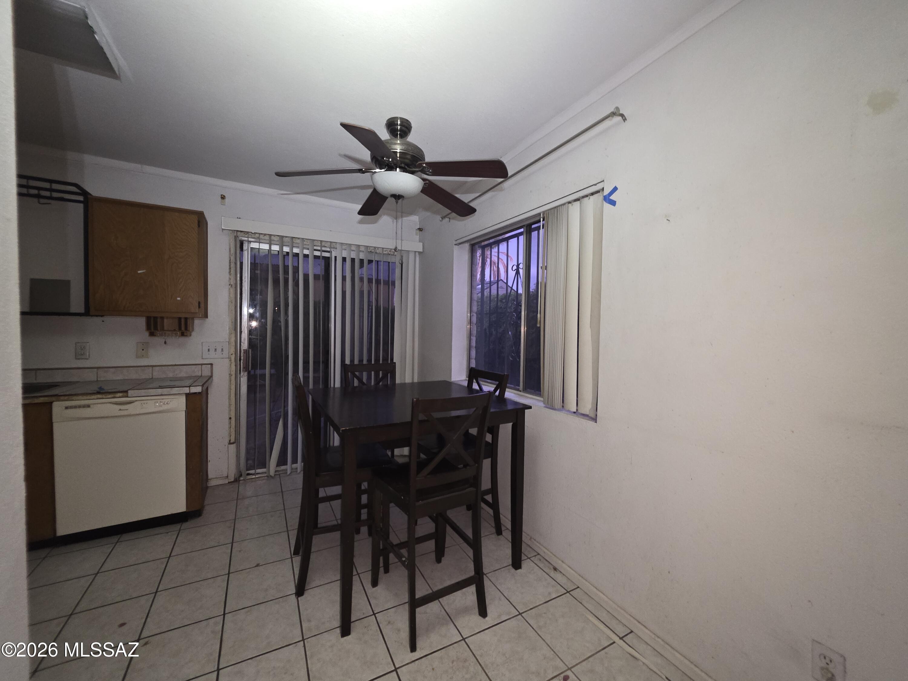211 West Roger Road, Unit 24 Tucson, AZ 85705 - Photo 7 of 24 a kitchen with stainless steel appliances a stove a refrigerator sink cabinets and chairs