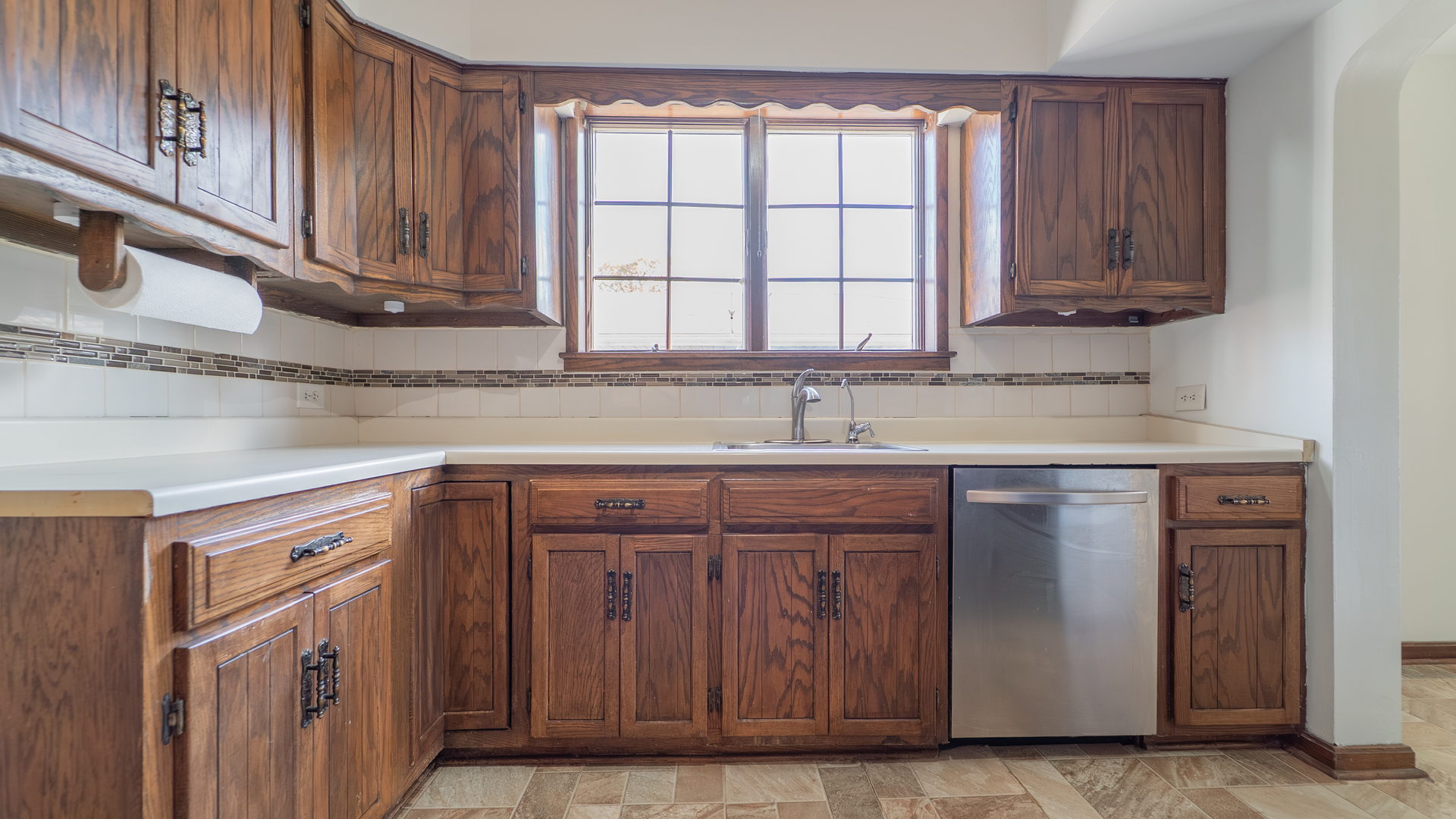 122 Elizabeth Street Calumet City, IL 60409 - Photo 5 of 31 a kitchen with stainless steel appliances granite countertop wooden cabinets a sink and a window