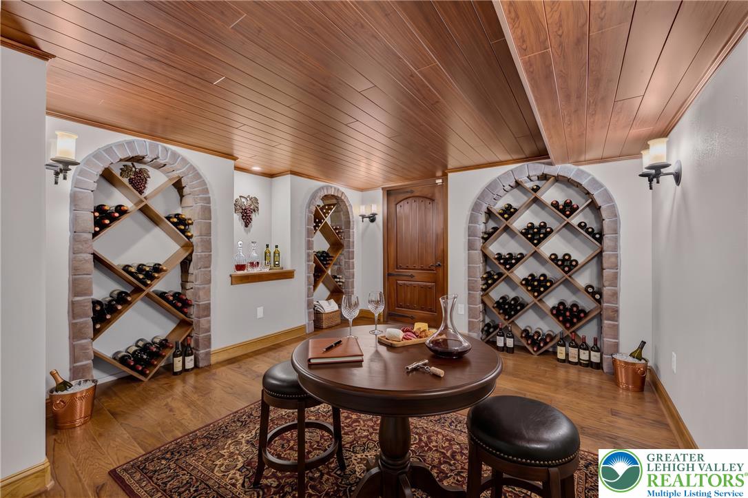 3130 Muirfield Road Center Valley, PA 18034 - Photo 52 of 63 Rich wood plank ceilings and built-in stone-arch bottle racks define this custom cellar.