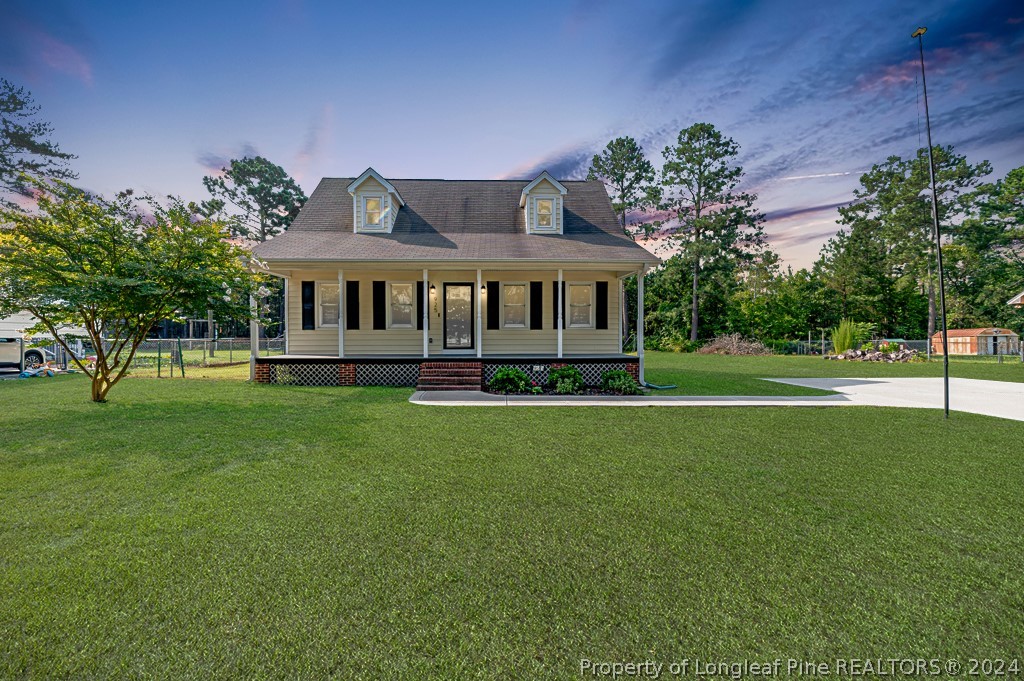 925 Line Road Cameron, NC 28326 - Photo 1 of 42 a front view of a house with a garden