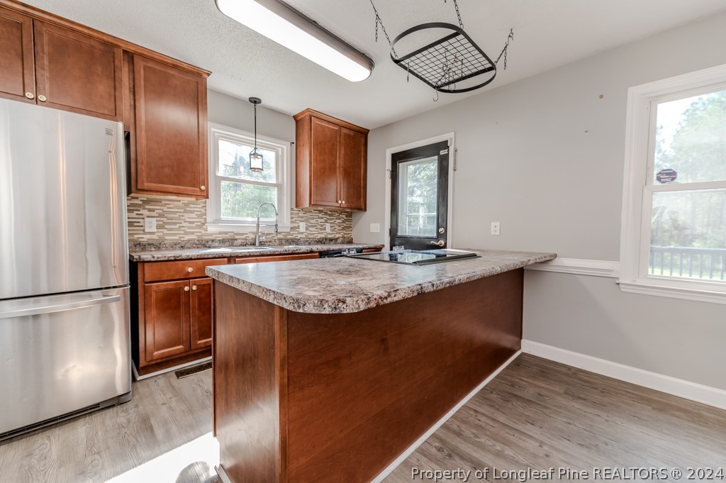 925 Line Road Cameron, NC 28326 - Photo 13 of 42 a kitchen with stainless steel appliances granite countertop a sink and a refrigerator