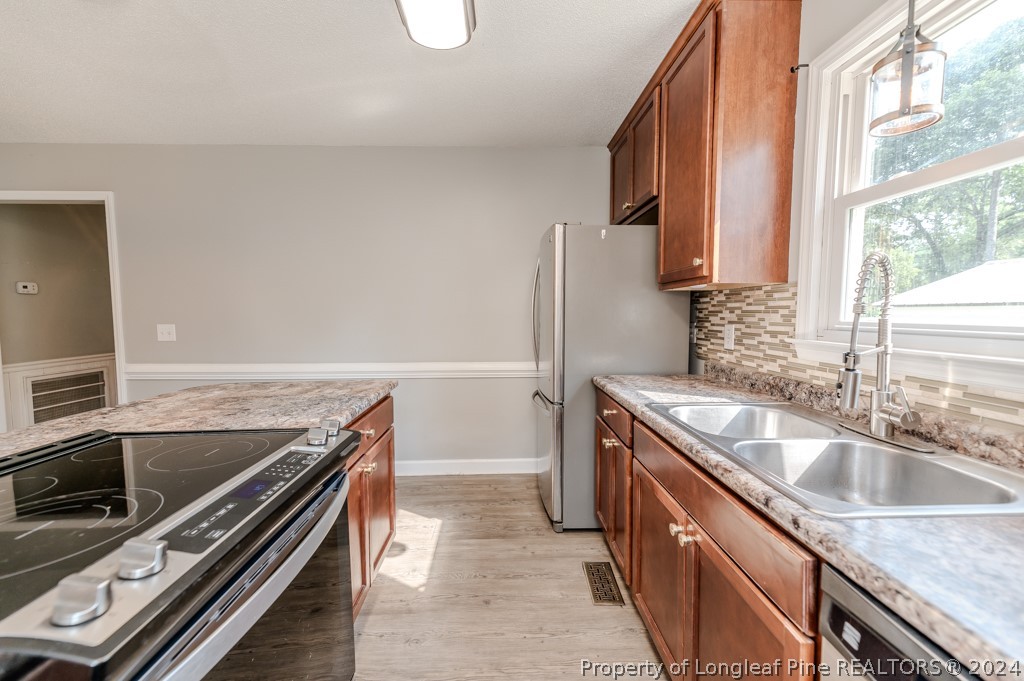 925 Line Road Cameron, NC 28326 - Photo 14 of 42 a kitchen with granite countertop a sink and a stove top oven
