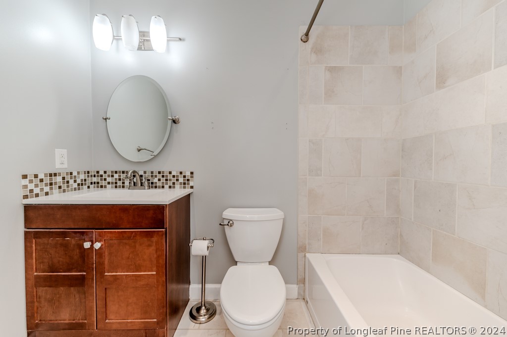 925 Line Road Cameron, NC 28326 - Photo 21 of 42 a bathroom with a toilet a sink and mirror
