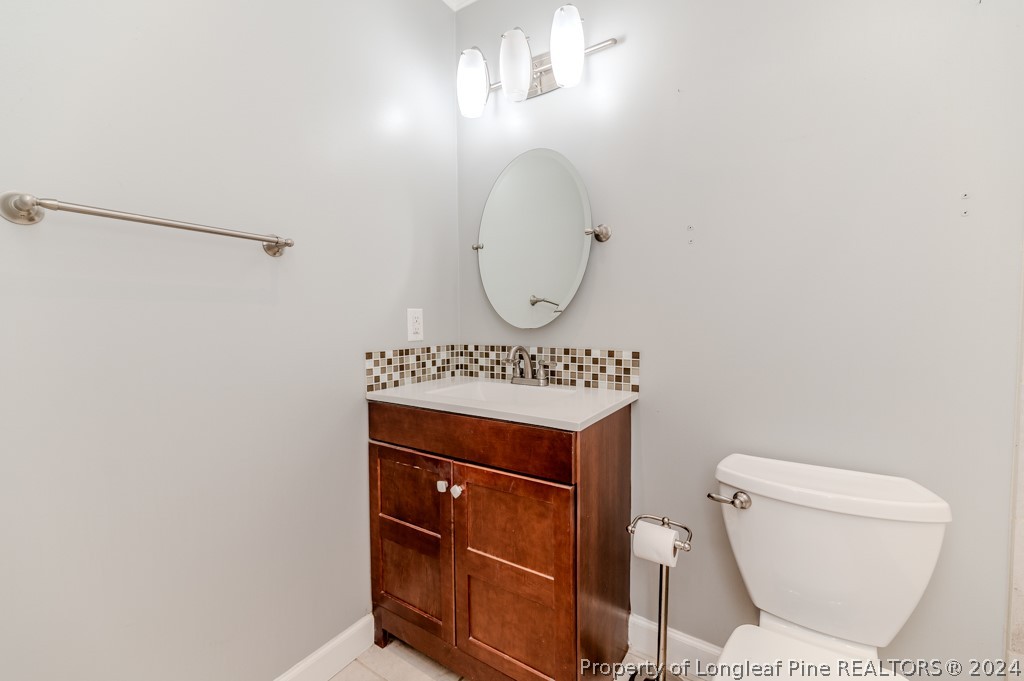 925 Line Road Cameron, NC 28326 - Photo 22 of 42 a bathroom with a toilet a sink and a mirror