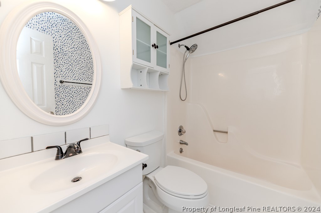 925 Line Road Cameron, NC 28326 - Photo 26 of 42 a bathroom with a sink a toilet and a mirror