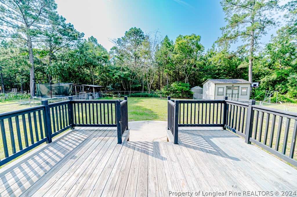 925 Line Road Cameron, NC 28326 - Photo 28 of 42 a view of a wooden deck with a yard
