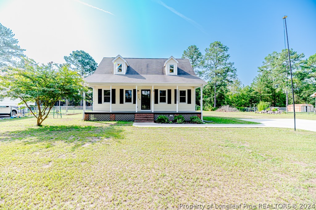 925 Line Road Cameron, NC 28326 - Photo 3 of 42 a front view of a house with a yard