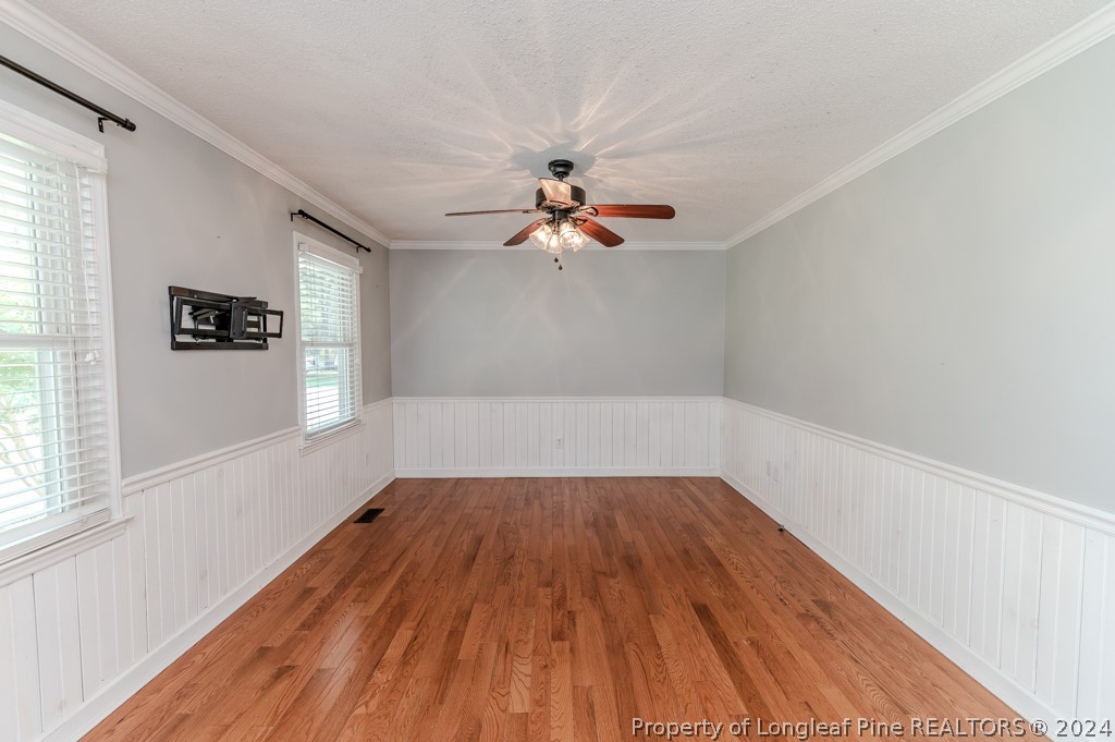 925 Line Road Cameron, NC 28326 - Photo 7 of 42 a view of a room with wooden floor and a ceiling fan