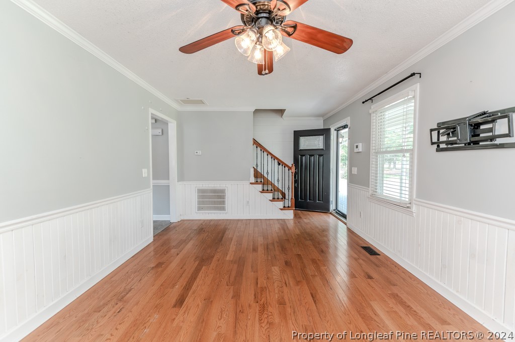 925 Line Road Cameron, NC 28326 - Photo 8 of 42 a view of a room with wooden floor ceiling fan and windows