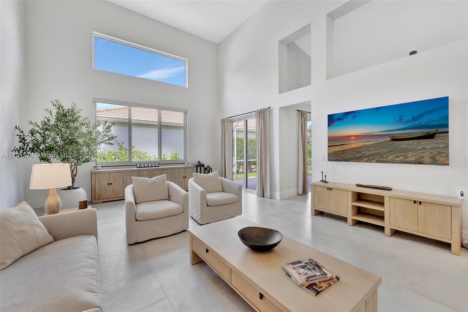 6393 Brava Way Boca Raton, FL 33433 - Photo 11 of 55 a living room with furniture and a flat screen tv