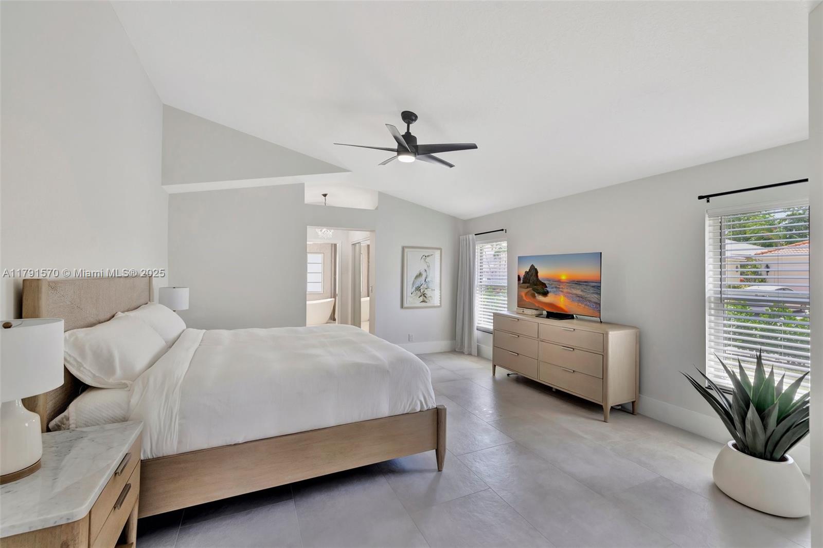 6393 Brava Way Boca Raton, FL 33433 - Photo 16 of 55 a bedroom with a bed and a chandelier