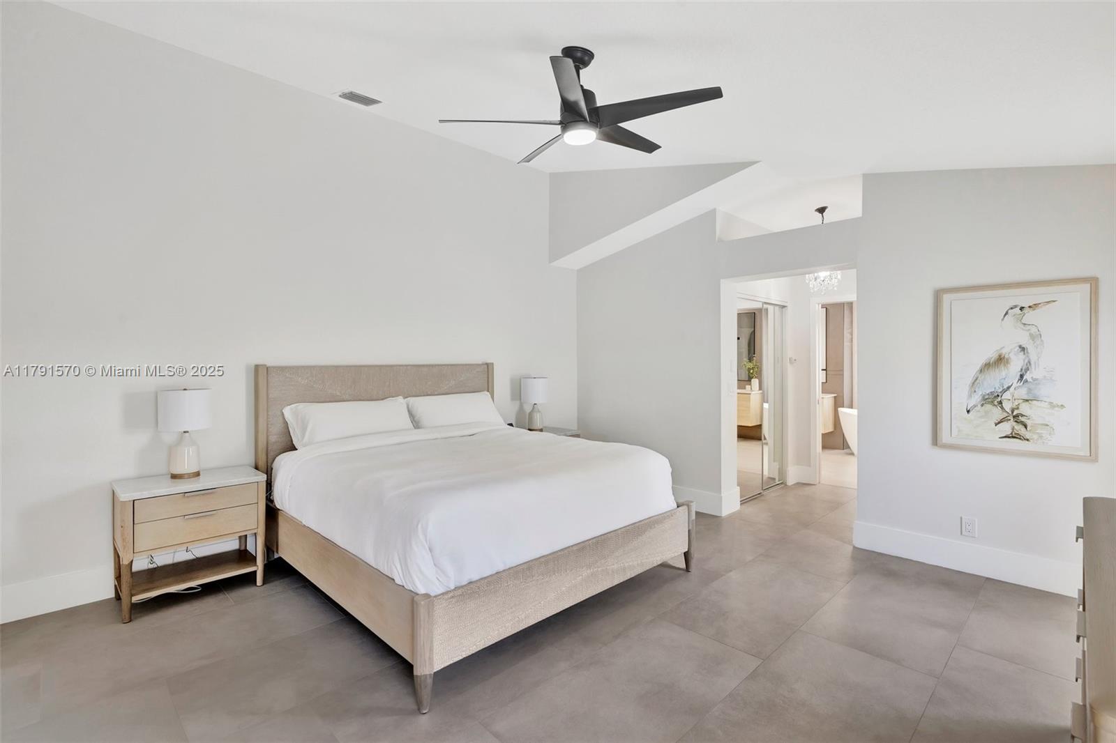 6393 Brava Way Boca Raton, FL 33433 - Photo 17 of 55 a bedroom with a bed and a painting on the wall