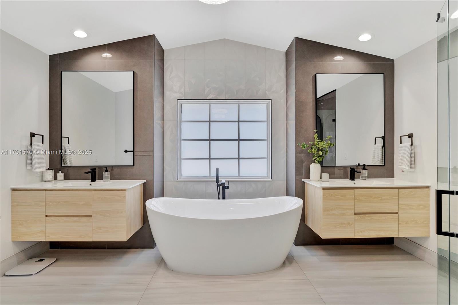 6393 Brava Way Boca Raton, FL 33433 - Photo 18 of 55 a bathroom with a double vanity sink mirror and bathtub