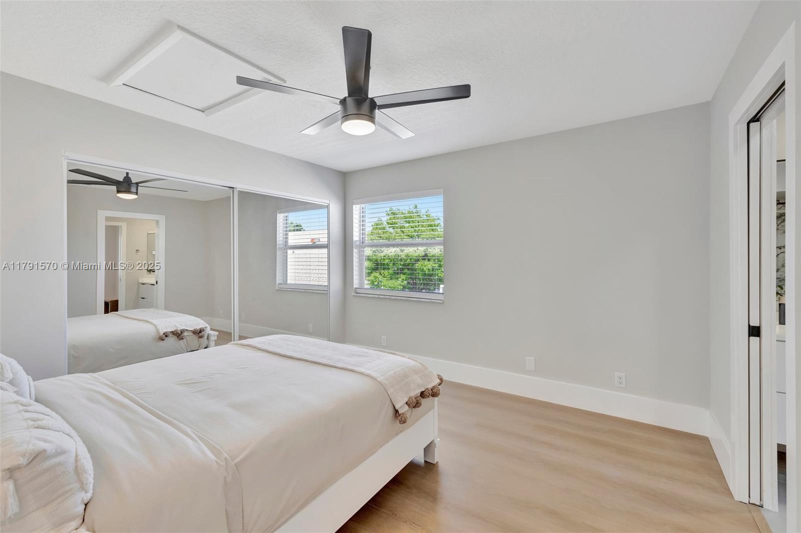 6393 Brava Way Boca Raton, FL 33433 - Photo 26 of 55 a bedroom with a large bed and a window