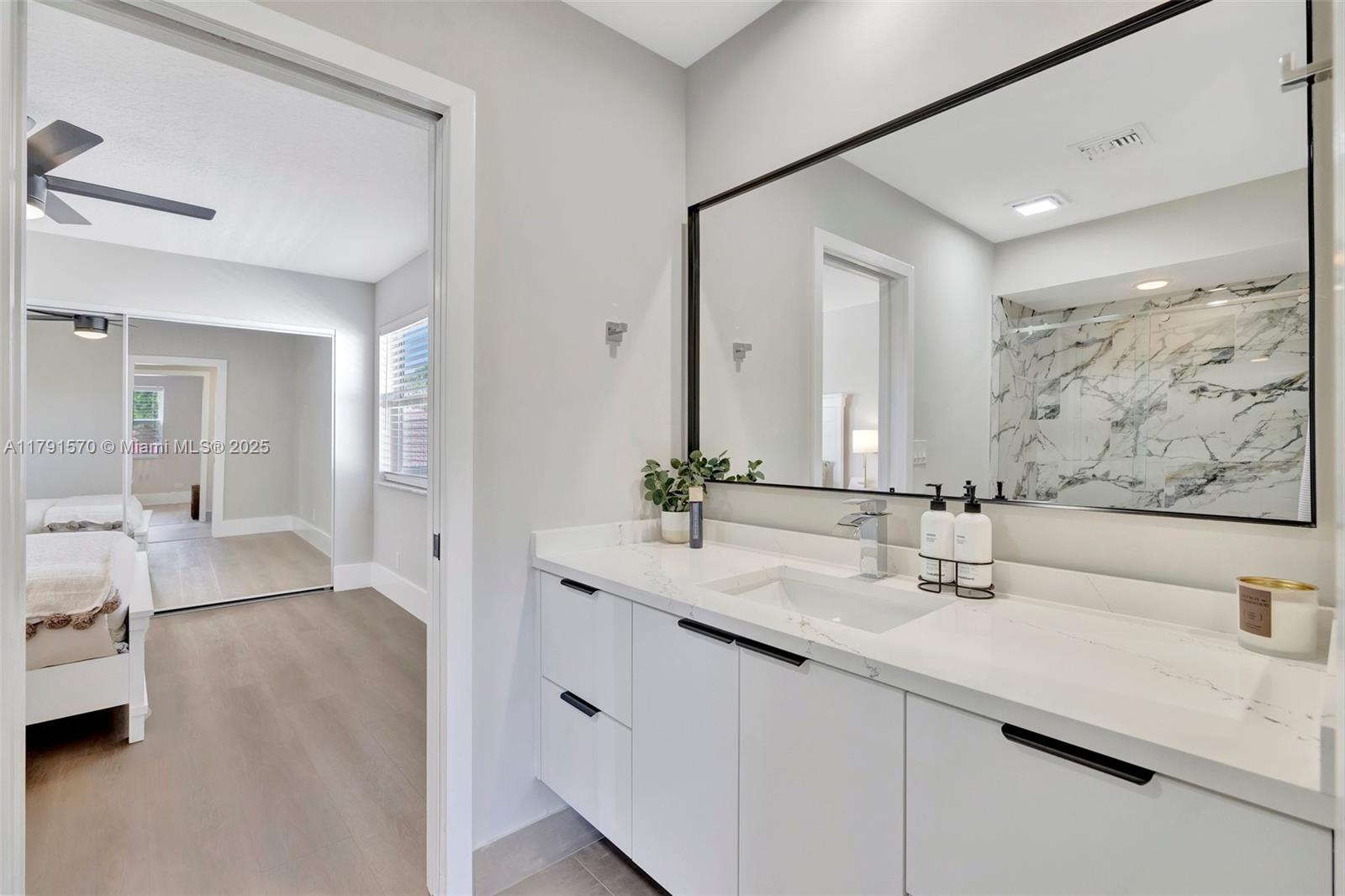 6393 Brava Way Boca Raton, FL 33433 - Photo 28 of 55 a bathroom with a double vanity sink mirror and double