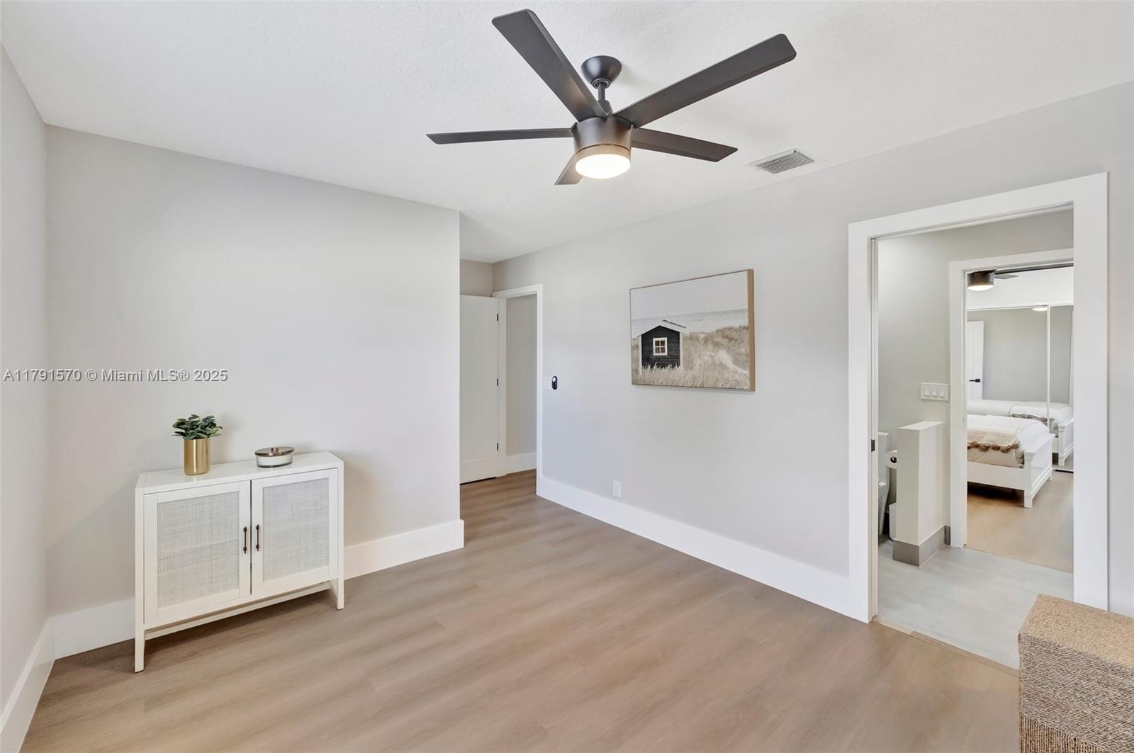 6393 Brava Way Boca Raton, FL 33433 - Photo 31 of 55 a view of a livingroom with wooden floor and a ceiling fan