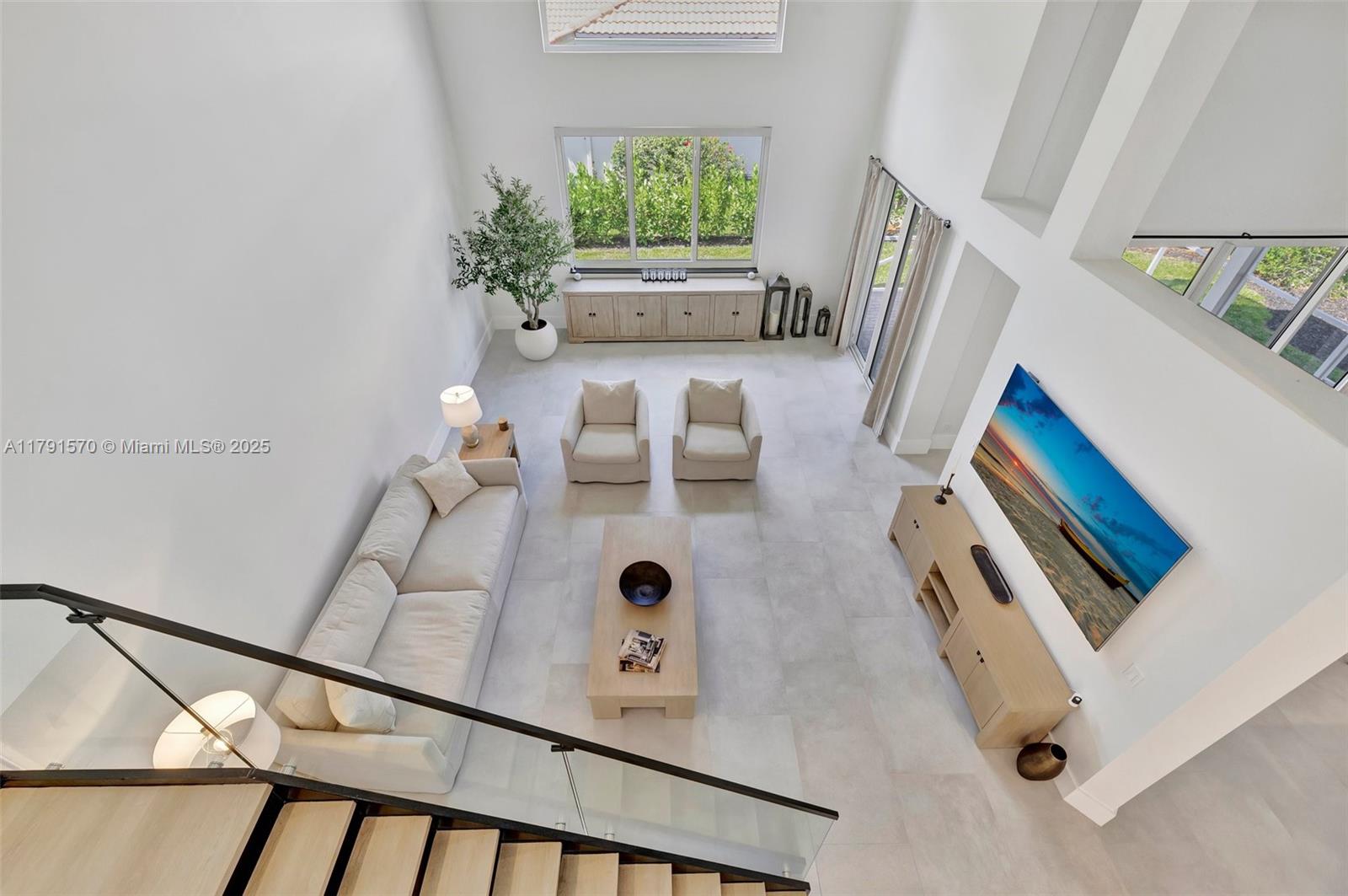 6393 Brava Way Boca Raton, FL 33433 - Photo 34 of 55 a living room with furniture and a large window