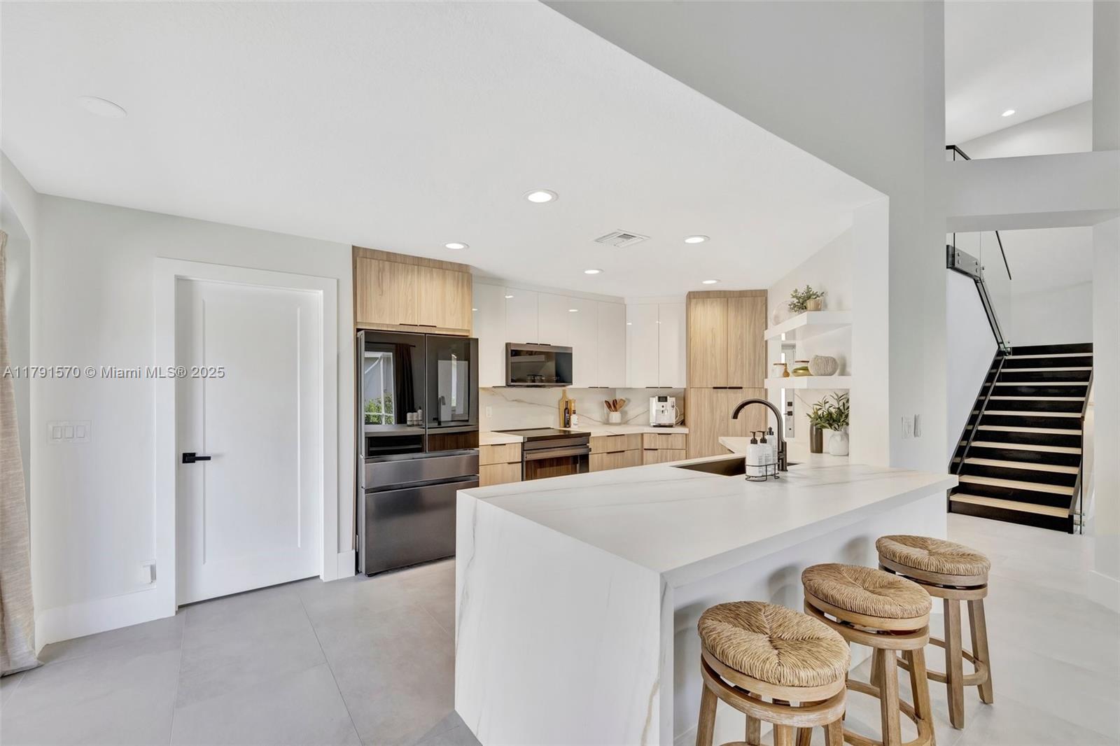 6393 Brava Way Boca Raton, FL 33433 - Photo 4 of 55 a kitchen with sink refrigerator and cabinets