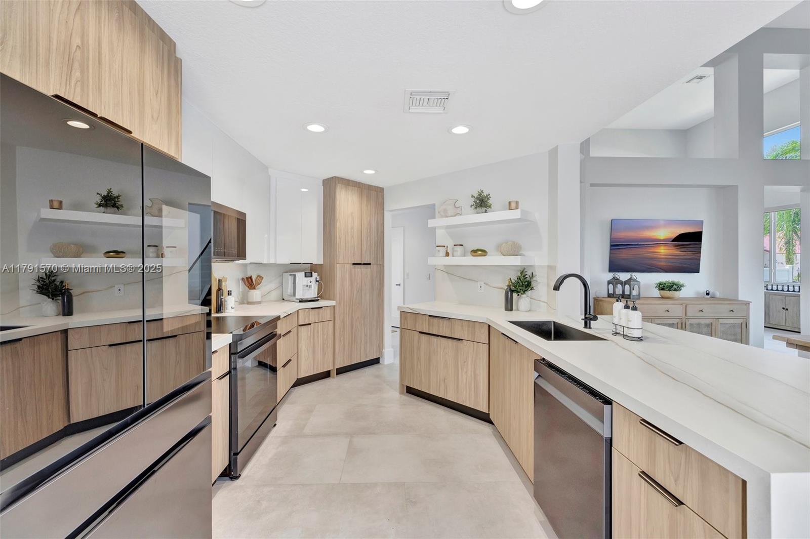 6393 Brava Way Boca Raton, FL 33433 - Photo 5 of 55 a large kitchen with stainless steel appliances a sink a stove and a refrigerator