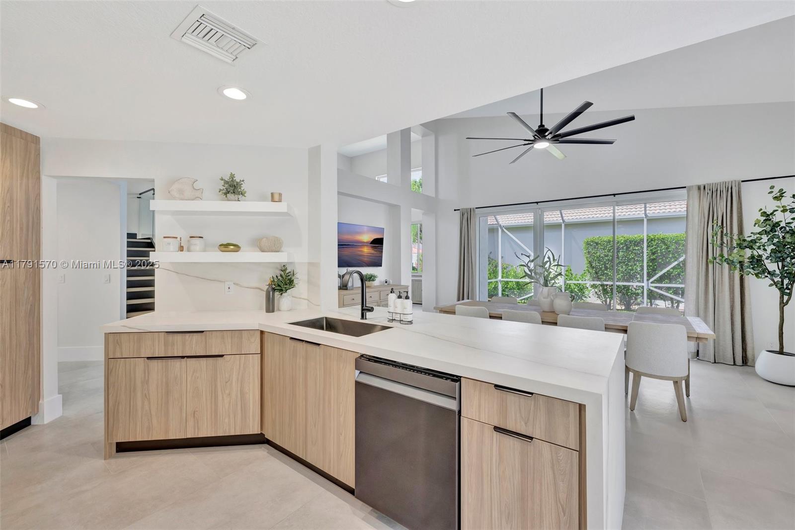 6393 Brava Way Boca Raton, FL 33433 - Photo 6 of 55 a kitchen with a sink a stove and cabinets