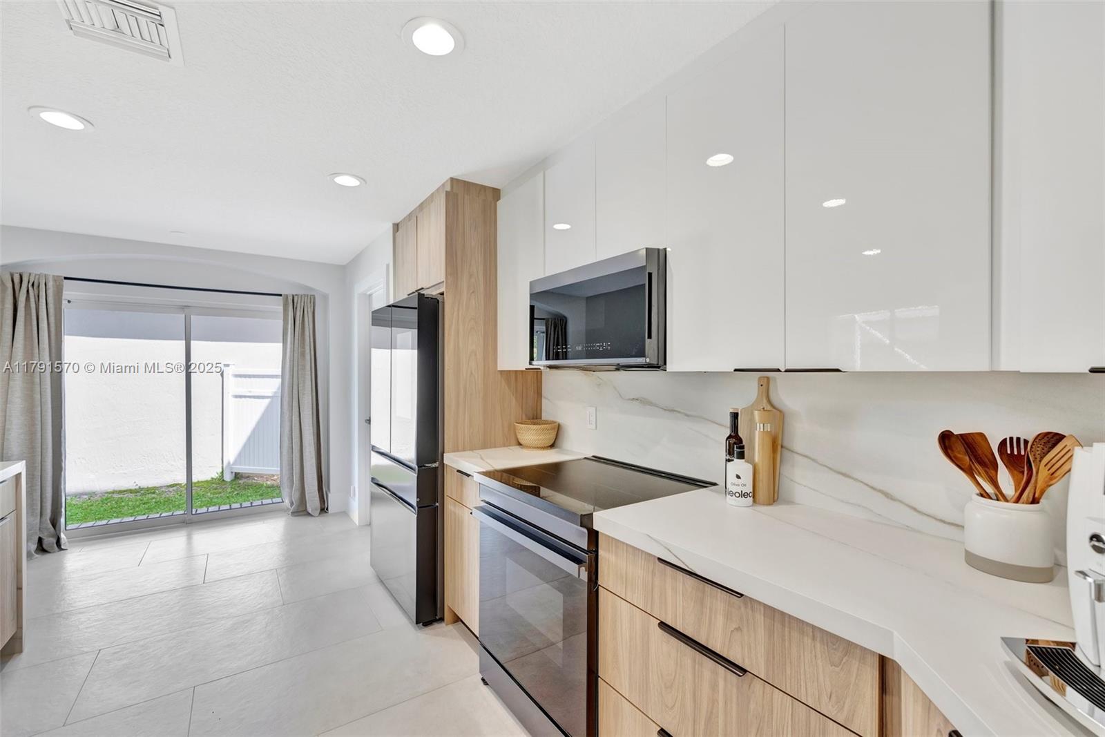 6393 Brava Way Boca Raton, FL 33433 - Photo 7 of 55 a kitchen that has a sink and a stove top oven