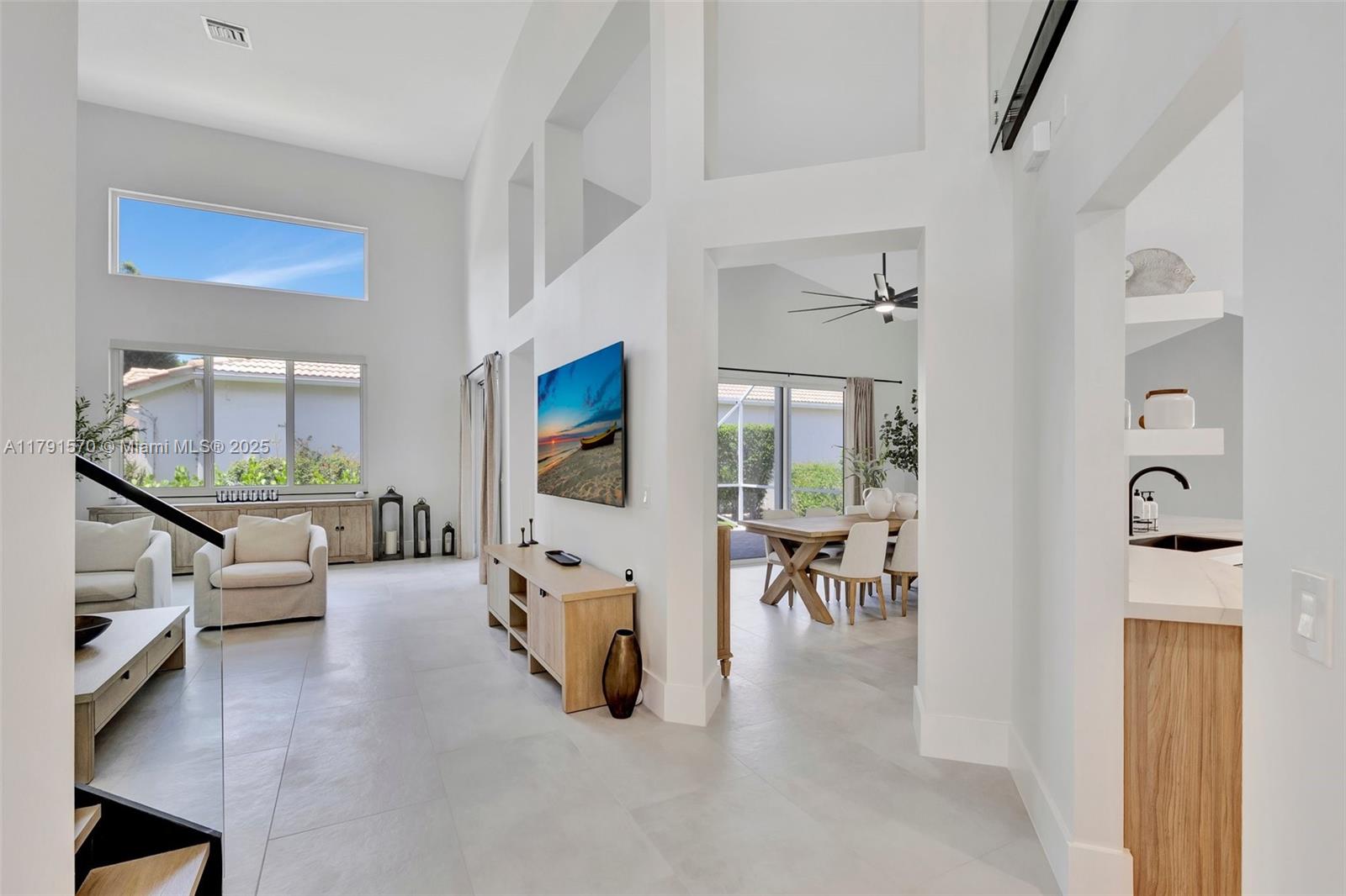 6393 Brava Way Boca Raton, FL 33433 - Photo 9 of 55 a living room with furniture large window and a table