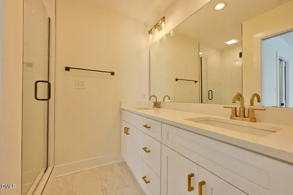 a bathroom with double vanity sink and a mirror